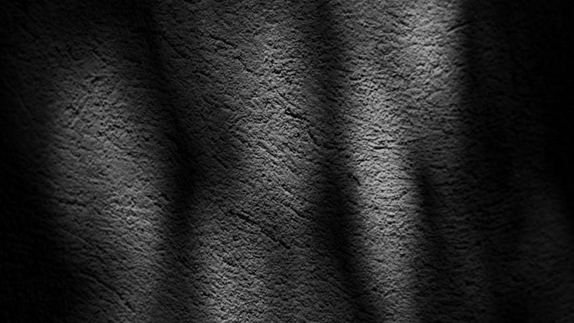 Abstract dark background with subtle light patterns representing focus.