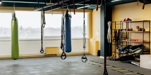 Empty gym space with minimal equipment, representing a place for discipline.