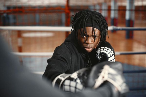 Man in athletic wear looking focused before a workout session.